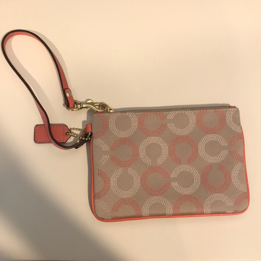 Coral and tan COACH wristlet